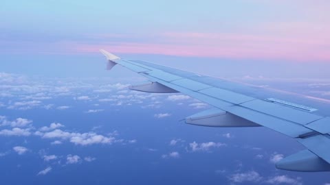 Pink sunset seen from a plane window