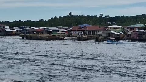 The Sea Gypsies of the Philippines, Arriving at Isabela, Basilan see many houses of the Badjao
