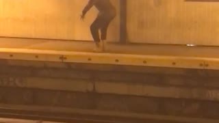 Man dancing night time subway station