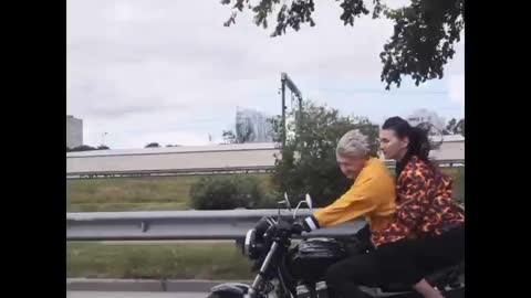 Couple riding a black motorcycle