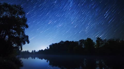 Beautiful bluish landscape of a lake and starry sky