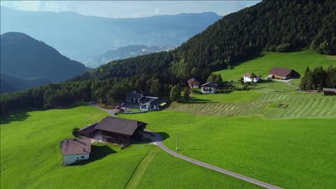 alpine fields houses and road drone aerial view of italian alps in summer beautiful landscapes