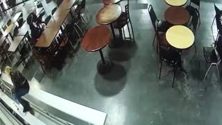 Security camera girl in black slips in restaurant