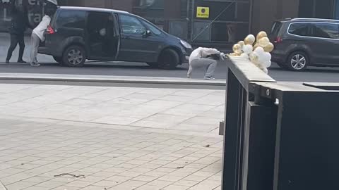 Balloons Drag Woman Down in Heavy Wind