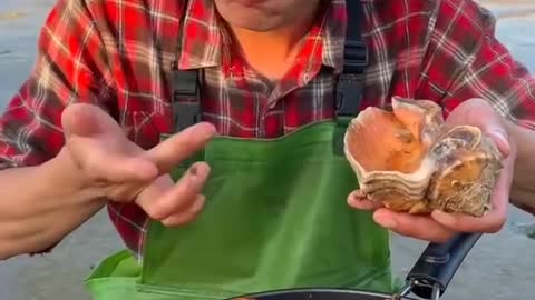 Young man cooking and eating seafood look like so delicious