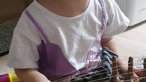 A child playing traditional Korean musical instruments