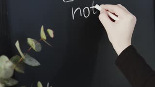 Writing A Message In A Blackboard Using A Chalk