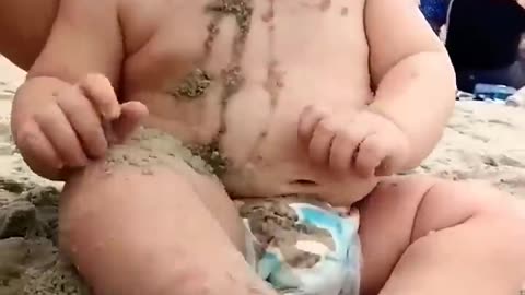 funny baby reaction on beach