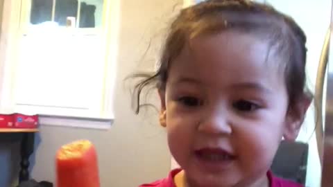 Red shirt toddler child calls carrot tit