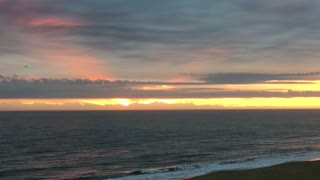 Ocean Sunrise brightening the cloudy sky