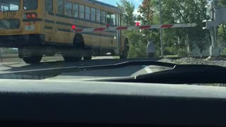 School Bus Crosses Closed Train Tracks