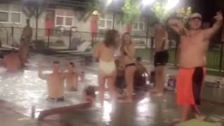 Music people dancing in pool and girl dancing along