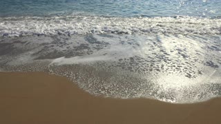 Waves Reaching Sand On A Beach