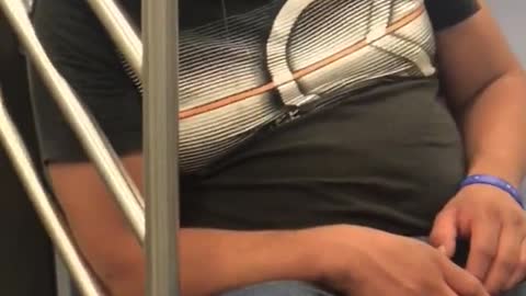 Man asleep on train with drool coming out of mouth