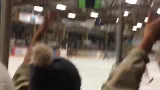 Hockey player runs into glass and knocks over tower of stacked cups