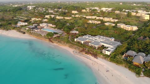 Top view of stunning thatched house on Zanzibar Nungwi Beach in the evening with blue Indian Ocean