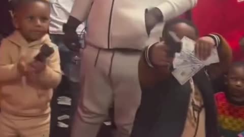 Sad! Black Boys Mimic Rappers with Guns and Money at a Birthday Party