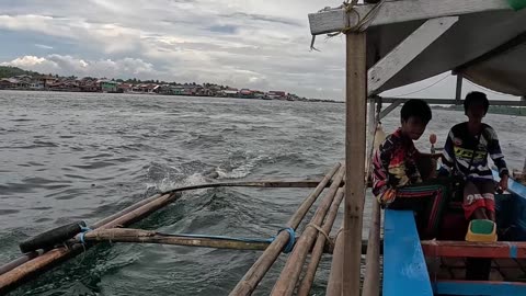 A traditional Bangka, motorized outrigger canoe ride from Malamawi Island to Isabela City Port