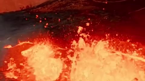 Spectacular drone flight over lava flows and an erupting volcano in Iceland.