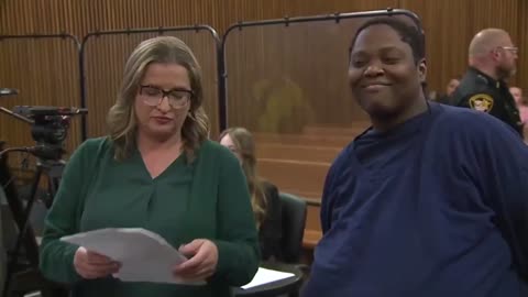 Woman who is accused of killing a 3-year-old boy in a grocery store parking lot smirks in court