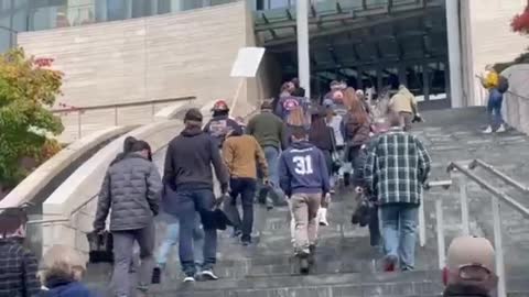 Seattle Fire and Police, discharged W/O Jab silently turn in their boots at the city hall.