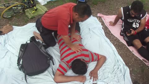Luodong Briefly Massages Young Man In Striped Shirt At The Park