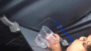 Kid blue shirt spilling water from straw