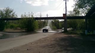Drivers Use Busted Water Pipeline as Car Wash