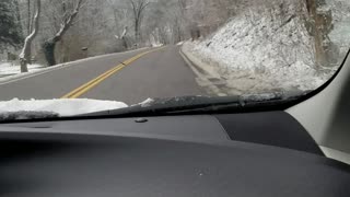 Driving a country road during snowfall