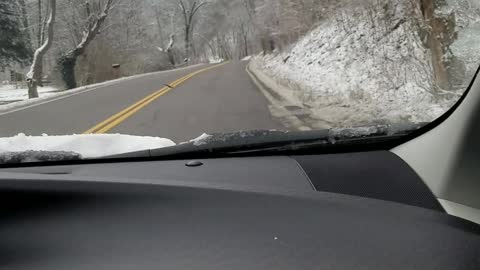 Driving a country road during snowfall