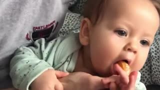 Baby is Determined to Get Orange Slice
