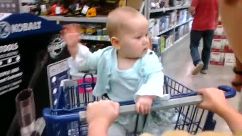 Baby waving at everyone in Lowe's Supermarket