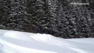 Red sweater white helmet skiier attempts front flip and fails
