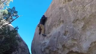 Guy black jacket rock climbing fall
