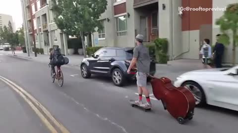 Skating with upright bass on wheels, downtown la