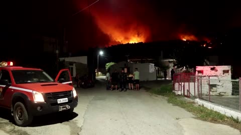 Greek firefighters battle to keep wildfire from villages