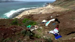 Migrants leave Red Cross camp for island cliffside