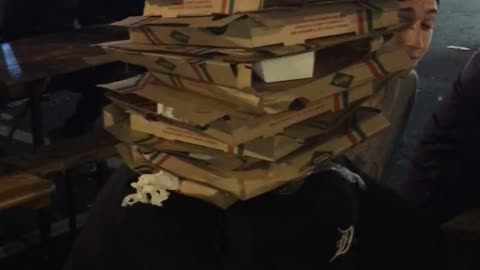 Music pizza boxes stacked up on one another in trashcan