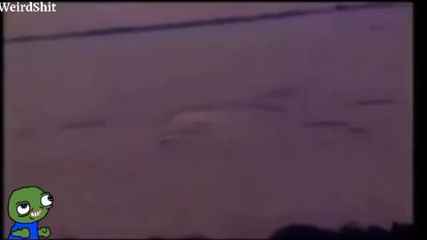 A CROP CIRCLE BEING CREATED BY A UFO FOR THE FIRST TIME CAUGHT ON FILM