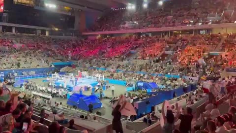 Woman holds up giant ‘XX’ banner whilst staging a protest at the Paris Olympics