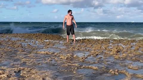 Big Wave Plows Over Man on Beach