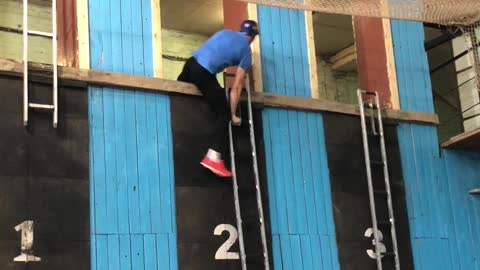 Competitive Firefighter Climbs Up Ladder