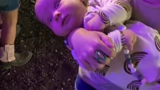 Baby Looks Terrified While Being Held By 6 Year Old Sister