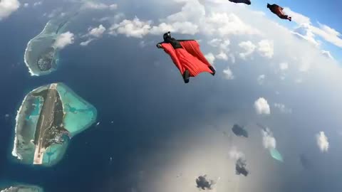 Wingsuit flying over Maldives island