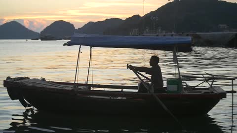 Traditional Vietnamese Boat on Ha Long Bay at Sunset