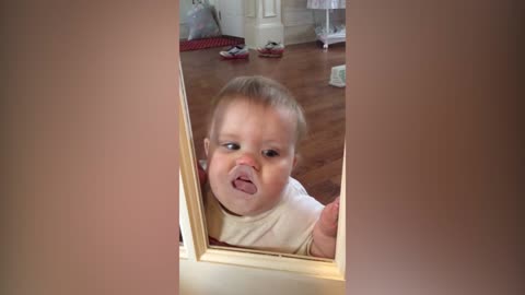 Baby loves making funny faces through the glass door