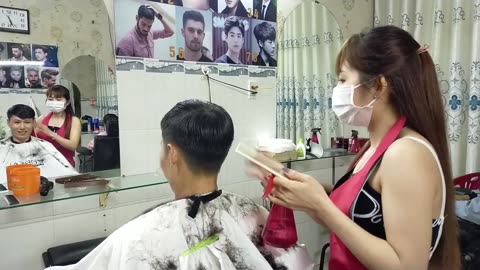 Professional men's haircut with a beautiful barber at Vietnamese barber shop