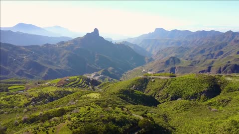 flying over lush landscape and mountains at gran canaria