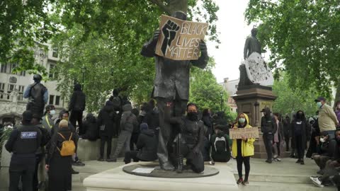 London Black Lives Matter Protester Poses by Nelson Mandela Statue