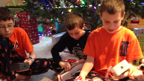 Kids tearing open their christmas gifts and reacting